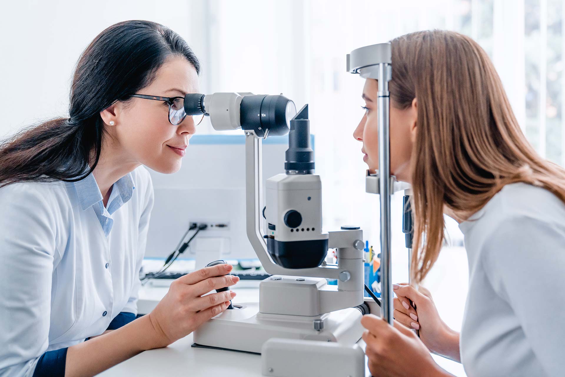 Ophthalmologist conducting an eye examination on a woman